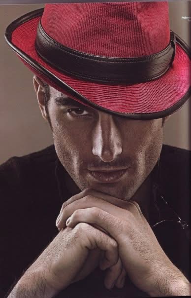 Fashion editorial: close portrait with a red hat and dark jacket.